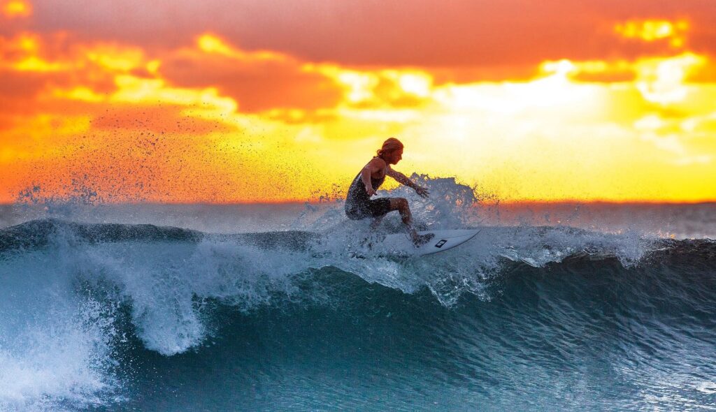 Surfer dad surfing in Cornwall